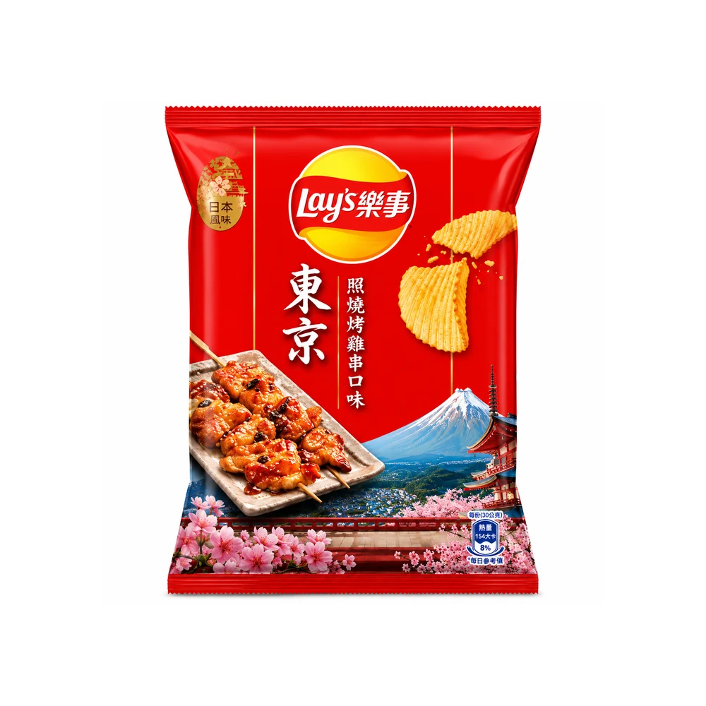 A package of Lay's Tokyo flavor potato chips on a plain white background. The packaging is predominantly red with a yellow Lay's logo, an illustration of grilled skewers, Mount Fuji, and pink cherry blossoms.