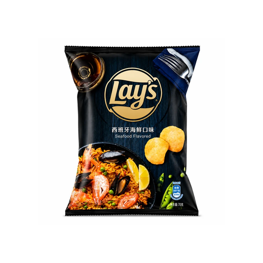 A bag of Lay's Seafood Flavored potato chips on a plain white background. The packaging is predominantly black with a gold circular Lay's logo, a photo of a seafood paella dish, and illustrations of potato chips and lemon wedges.