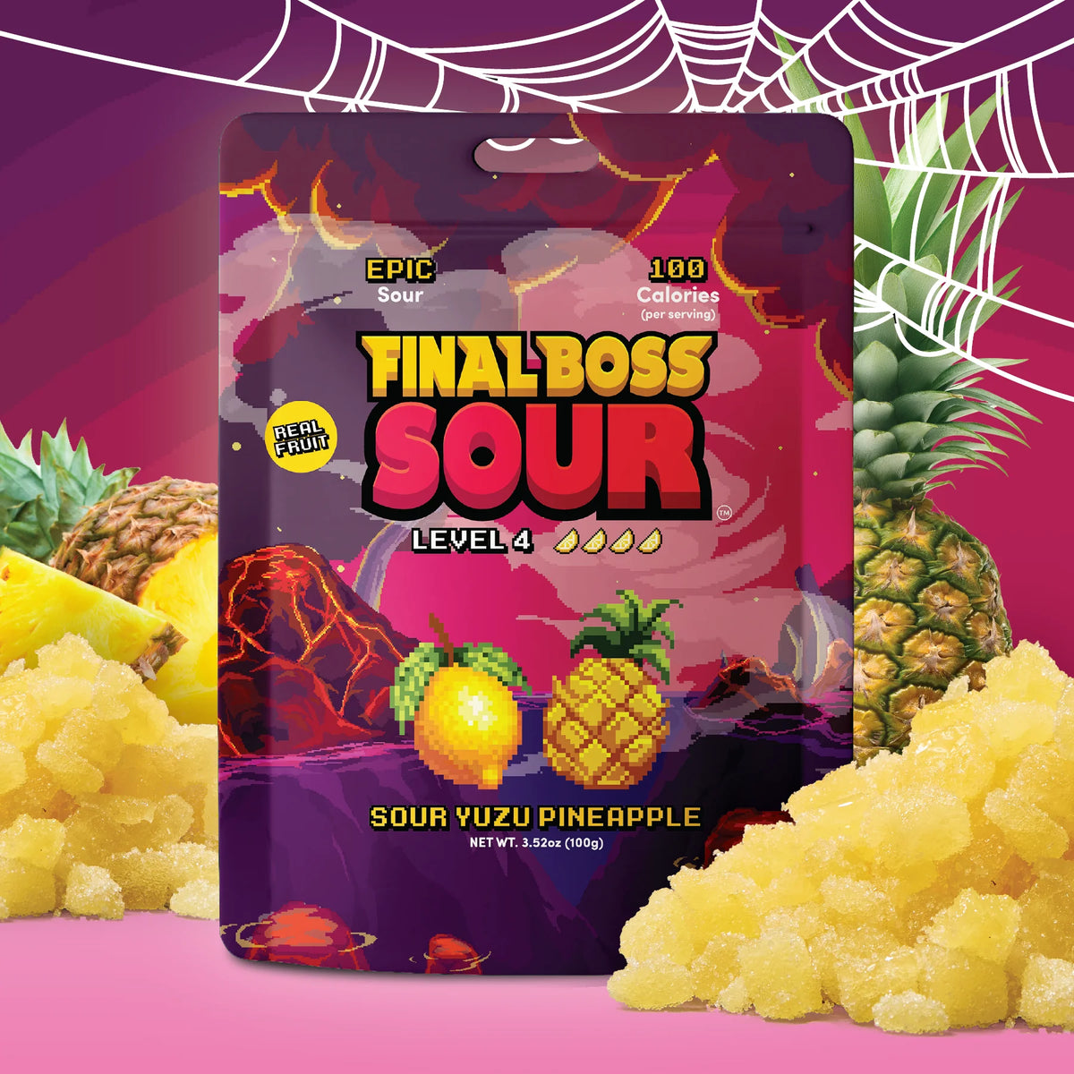 A package of Final Boss Sour Level 4 candy in Sour Yuzu Pineapple flavor, shown in a stylized graphic layout with pineapples, crushed yellow candy, and a pink background with spiderweb motifs.