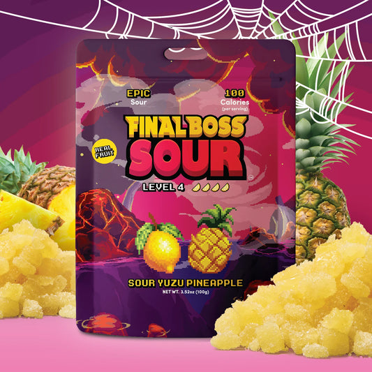 A package of Final Boss Sour Level 4 candy in Sour Yuzu Pineapple flavor, shown in a stylized graphic layout with pineapples, crushed yellow candy, and a pink background with spiderweb motifs.